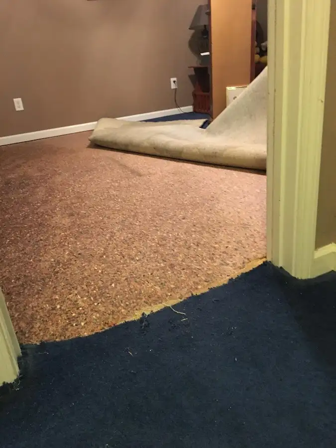 Carpet pad removal revealing water damage during Water Mitigation Services in West Carson